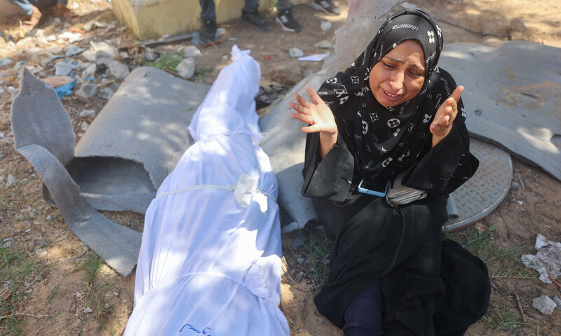 A Palestinian woman mourns by the body of a relative killed in an Israeli strike which hit a makeshift prayer hall at al-Shati refugee camp west of Gaza City on July 13, 2024.&mdash;AFP