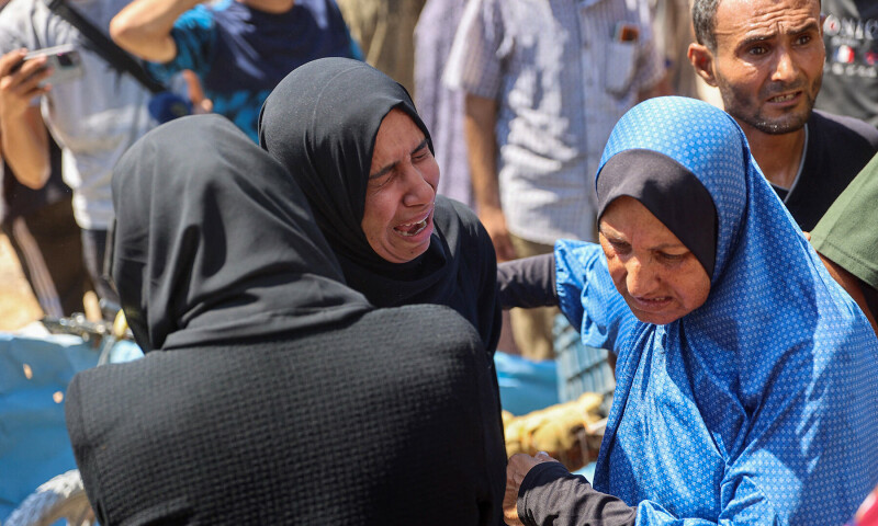 Palestinian women mourn by the bodies of relatives killed in an Israeli strike which hit a makeshift prayer hall at al-Shati refugee camp west of Gaza City on July 13, 2024..&mdash;AFP