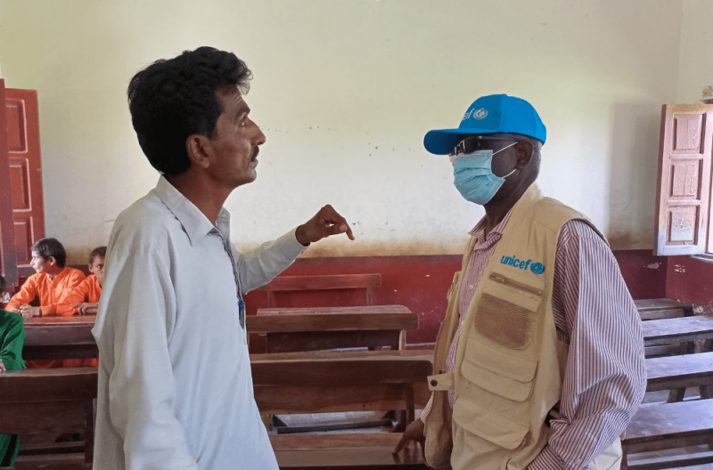  A school teacher briefing a UN representative from Kenya about the conditions of the schools 