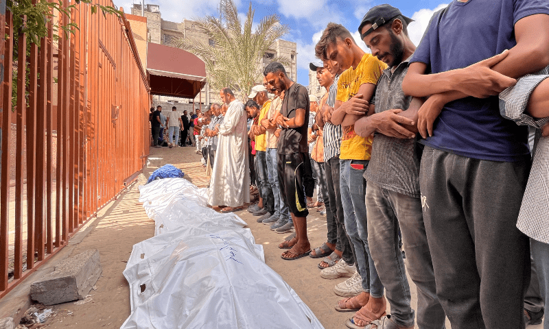  Mourners pray near the bodies of Palestinians killed in Israeli strikes at Nasser hospital in Khan Younis in the southern Gaza Strip on Aug 8, 2024. &mdash; Reuters 