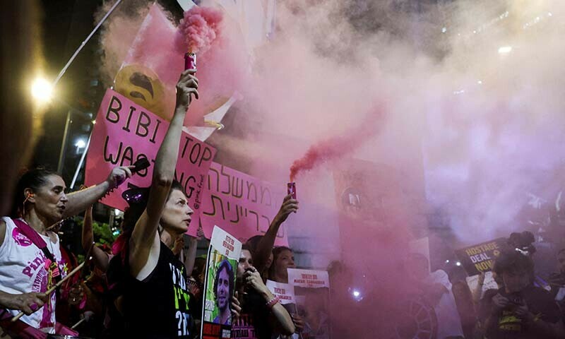  Demonstrators hold flares during a protest against Israeli Prime Minister Benjamin Netanyahu&rsquo;s government in Tel Aviv on August 10. &mdash; Reuters 