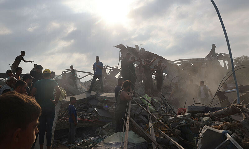  Palestinians inspect the site of an Israeli strike in Al-Zawayda in the central Gaza Strip on August 17. &mdash; AFP 