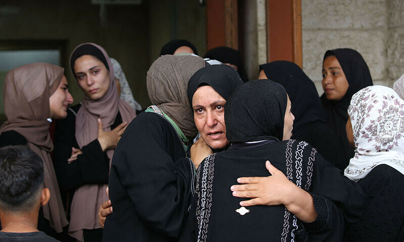  Palestinians at the Al-Aqsa Martyrs hospital mourn relatives killed in an Israeli strike in Al-Zawayda on August 17. &mdash; AFP 
