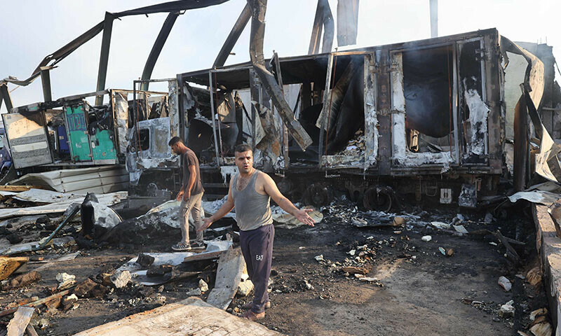  Palestinians inspect the site of an Israeli strike in Al-Zawayda in the central Gaza Strip on August 17. &mdash; AFP 