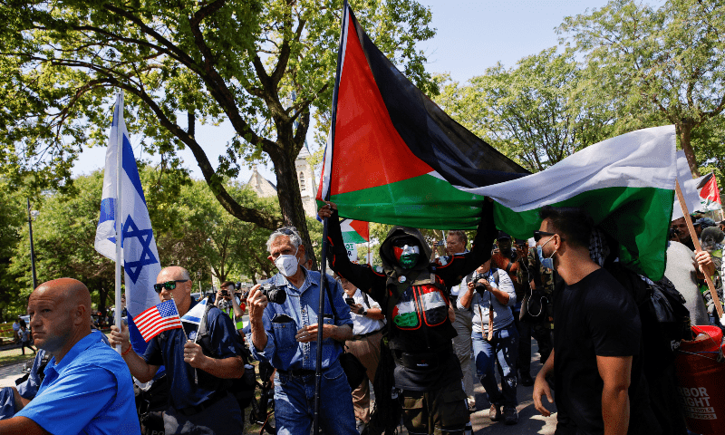 A person holds a flag in support of Palestinians in Gaza as demonstrators rally on the sidelines of the Democratic National Convention (DNC) in Chicago, Illinois, US on Aug 19, 2024. &mdash; Reuters 
