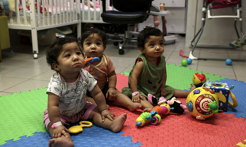 Palestinian triplets of Gaza-native Hanane Bayouk, Najmeh (L), Najoua (C) and Noor, play at the children&rsquo;s ward of the Al-Maqased Hospital in east Jerusalem on July 31, 2024. &mdash; AFP