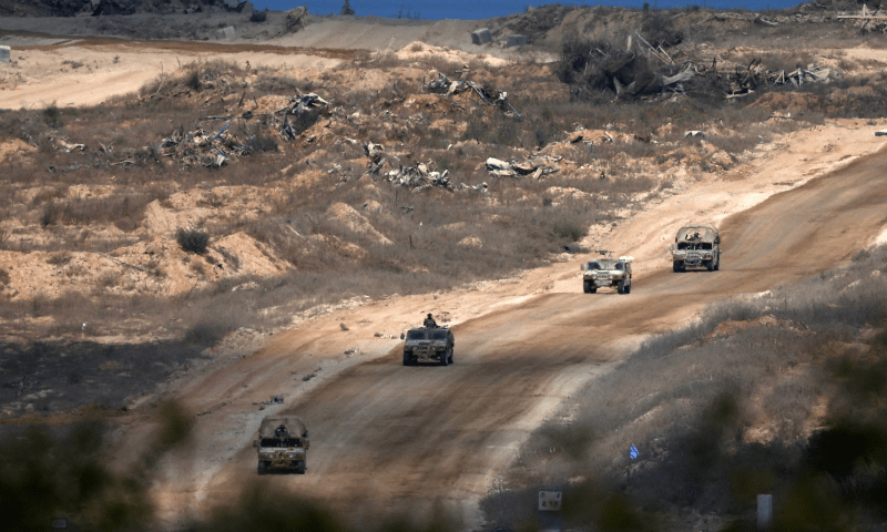  Israeli military vehicles manoeuvre, near the Israel-Gaza border, as seen from Israel on Aug 23, 2024. &mdash; Reuters 