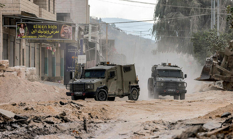 Israeli army armoured vehicles move along a road during a military operation in Tulkarm in the north of the occupied West Bank on August 29, 2024. &mdash; AFP