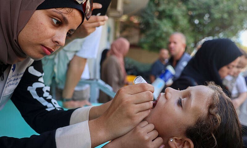  A health worker administers a polio vaccine to a Palestinian child in Zawayda in the central Gaza Strip on September 1. The World Health Organisation said Israel had agreed to at least three days of &ldquo;humanitarian pauses&rdquo; in fighting in parts of Gaza, starting on August 31, to facilitate the vaccination drive. &mdash; AFP 