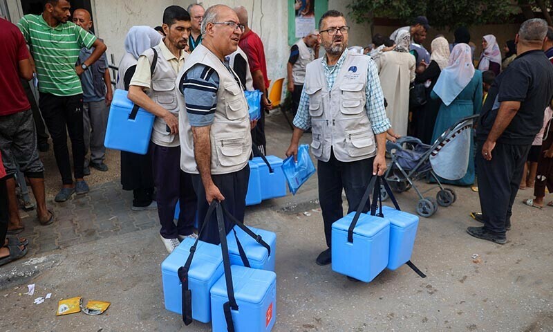  Health workers carry containers filled with Polio vaccines during a vaccination campaign in Zawayda in the central Gaza Strip on September 1. The World Health Organisation said Israel had agreed to at least three days of &ldquo;humanitarian pauses&rdquo; infighting in parts of Gaza, starting on August 31, to facilitate the vaccination drive. &mdash; AFP 