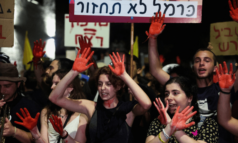 Protesters raise their hands painted in red during a demonstration calling for the immediate return of hostages held in Gaza, amid the ongoing conflict between Israel and Hamas, near Israeli PM Benjamin Netanyahu’s residence in Jerusalem on Sept 2, 2024. — Reuters/Ronen Zvulun