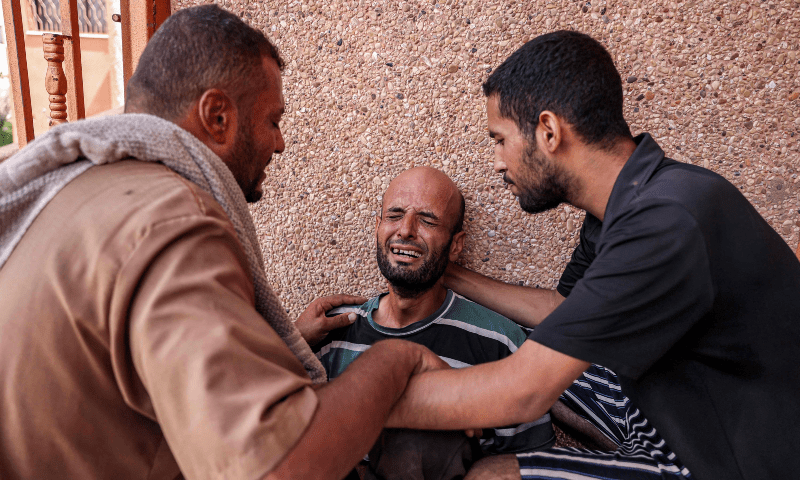  A man is comforted as he mourns his son who was killed in Israeli bombardment on a bakery, at Nasser Medical Complex in Khan Yunis in the southern Gaza Strip on Sept 16, 2024. &mdash; AFP 