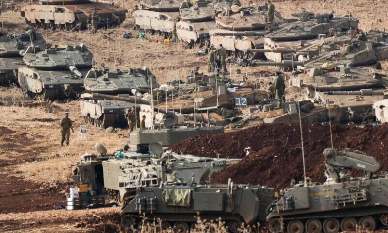 Israeli soldiers work on tanks at a staging area in northern Israel near the Israel-Lebanon border &mdash; Baz Ratner/AP Photo