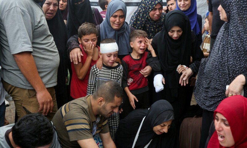  Children react next to the bodies of Palestinians, who were killed in Israeli strikes, at Al-Aqsa Martyrs Hospital in Deir Al-Balah in the central Gaza Strip on Oct 8, 2024. &mdash; Reuters 