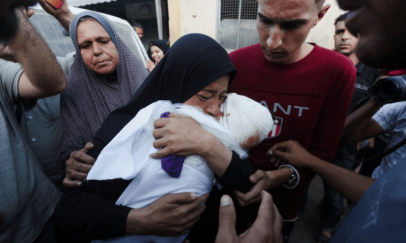 The grandmother of Palestinian boy Yaman Al-Zaanin, who was born and killed amid the ongoing conflict and lost his life in an Israeli strike on a school-turned-shelter, carries his body at Al-Aqsa Martyrs Hospital in Deir Al-Balah in the central Gaza Strip on Oct 14. — Reuters