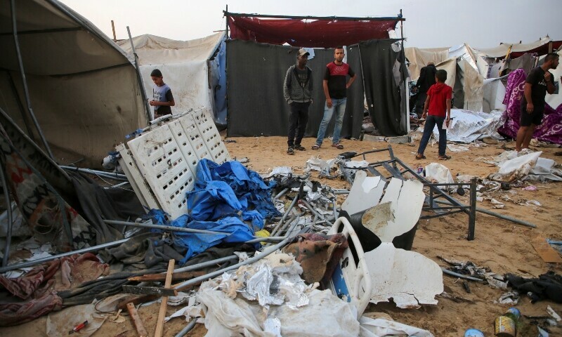 Palestinians inspect the damage at the site of an Israeli strike on a tent camp sheltering displaced people, amid the ongoing Gaza conflict, in Al-Mawasi area in Khan Younis, in the southern Gaza Strip on October 15. &mdash; Reuters