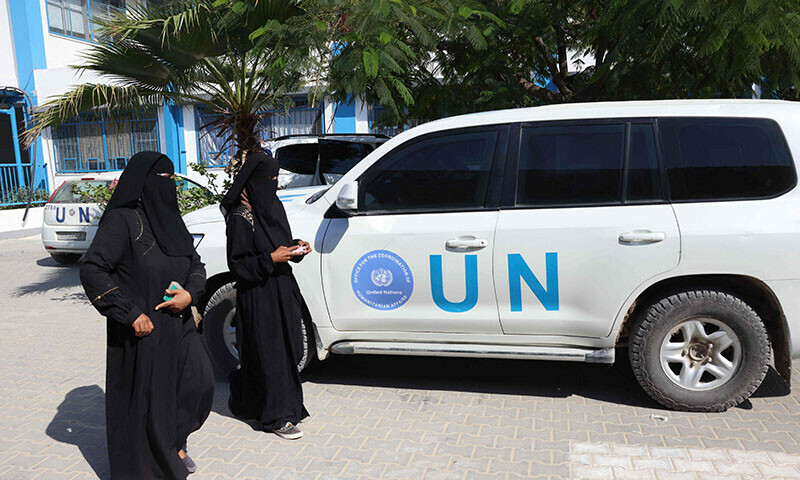 Palestinians walk past a UN vehicles at the UNRWA Japanese Health Center in Khan Yunis on the southern Gaza Strip on October 29, amid the ongoing conflict between Israel and Hamas. &mdash; AFP