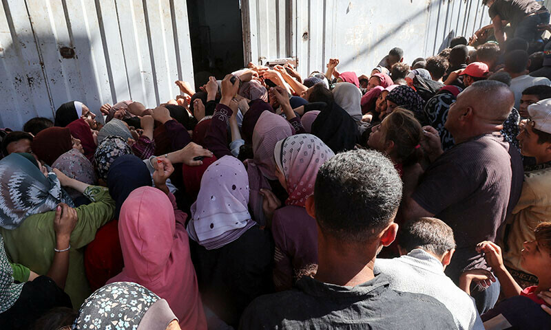 Palestinians gather to buy bread from a bakery, amid the Israel-Hamas conflict, in Deir Al-Balah in the central Gaza Strip on October 24. — Reuters
