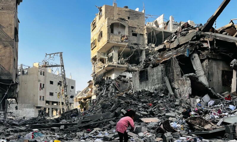 A Palestinian girl inspects the rubble of a building after an Israeli strike in Beit Lahia, in the northern Gaza Strip, on October 29, 2024. — AFP 