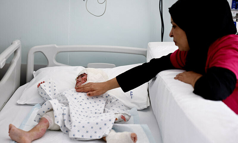 Fatima Zayoun caresses her two-year-old daughter Ivana Skayki, who suffered third-degree burns over nearly half of her body from an Israeli strike in southern Lebanon,lying in bed at Geitaoui Hospital in Beirut, Lebanon, October 30. — Reuters