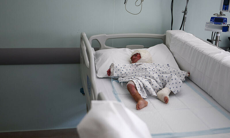 Two-year-old Ivana Skayki, who suffered third-degree burns over nearly half of her body from an Israeli strike in southern Lebanon, lies in bed at Geitaoui Hospital in Beirut, Lebanon, October 30. — Reuters