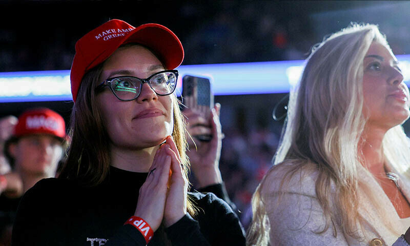 People gesture while attending a campaign rally by Republican presidential nominee and former US President Donald Trump in Grand Rapids, Michigan on November 5, 2024. &mdash;Reuters/Emily Elconin