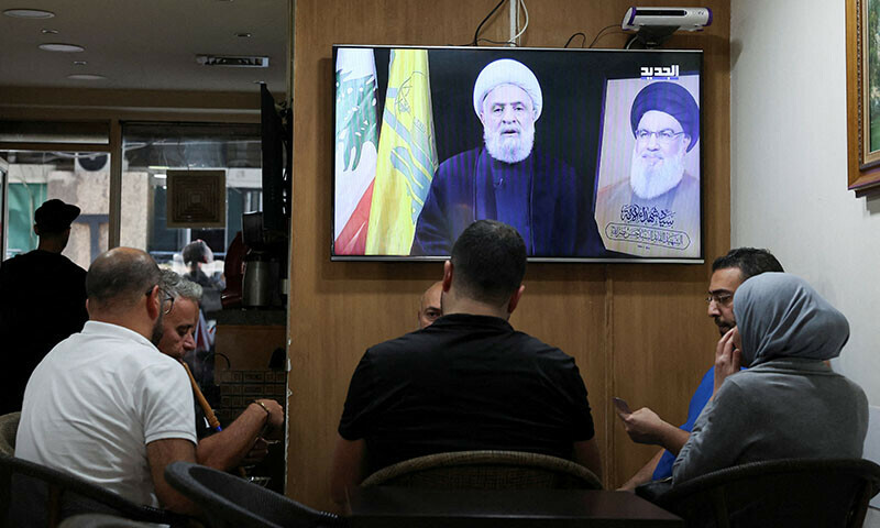 People sit in a cafe as they listen to Lebanon&rsquo;s Hezbollah new leader Sheikh Naim Qassem delivering a televised address, in Beirut, Lebanon on November 6. &mdash; Reuters
