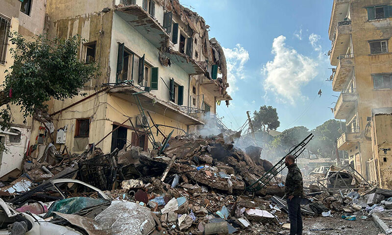 A man checks the destruction at the site of an Israeli airstrike targeting a neighborhood in southern Beirut on November 13. — AFP