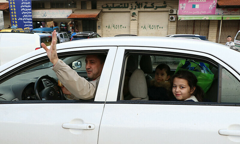 A man gestures as he and his family drive on a road in the village of Ferzol, in the eastern Beqaa valley on November 27 as displaced people make their way back to their homes after a ceasefire between Israel and Hezbollah took effect. &mdash; AFP