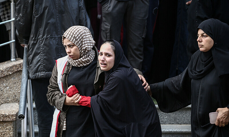Palestinian women react outside a hospital following an Israeli airstrike in the Nuseirat camp in the central Gaza Strip, on November 28. — AFP
