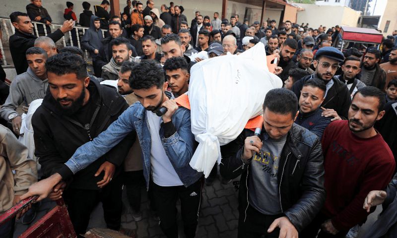  Men carry the bodies of Palestinians killed in Israeli strikes, at Al-Ahli Arab Baptist Hospital in Gaza City, on January 13, 2025. &mdash; Reuters/Dawoud Abu Alkas 