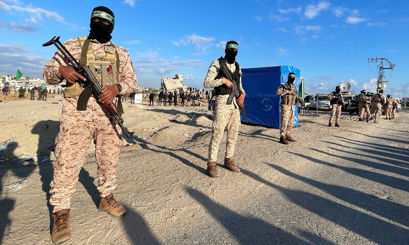 Hamas fighters stand guard as people gather ahead of the handover of hostages to members of the International Committee of the Red Cross (ICRC) as part of a ceasefire and a hostages-prisoners swap deal between Hamas and Israel, in Khan Younis in the southern Gaza Strip, February 1, 2025. — Reuters