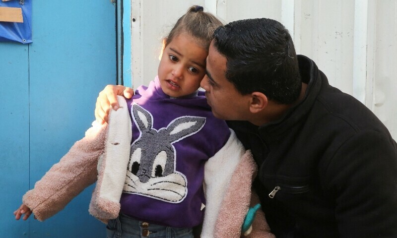  A Palestinian man holds a sick child before leaving Gaza for treatment abroad through Rafah crossing, in Khan Younis in the southern Gaza Strip, February 1, 2025.  &mdash; Reuters 