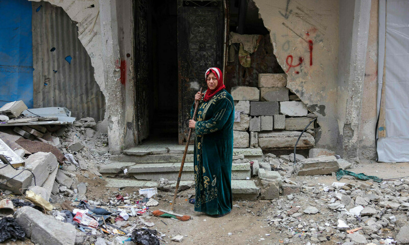 In pictures: Palestinians pose in front of their destroyed homes in Gaza