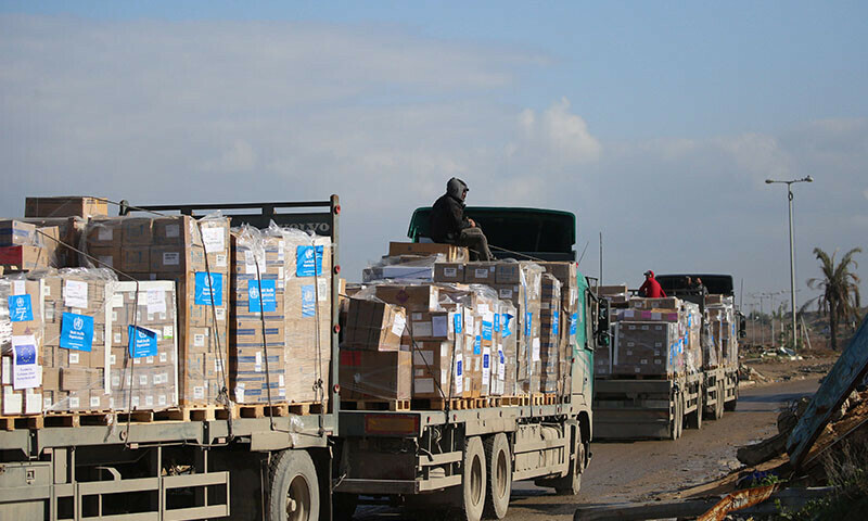 Trucks carrying WHO aid prepare to cross a checkpoint on Salah al-Din road in al-Mughraqa in the central Gaza Strip on February 13 as people and goods move towards the northern parts of Gaza during a current ceasefire deal in the conflict between Israel and Hamas. &mdash; AFP