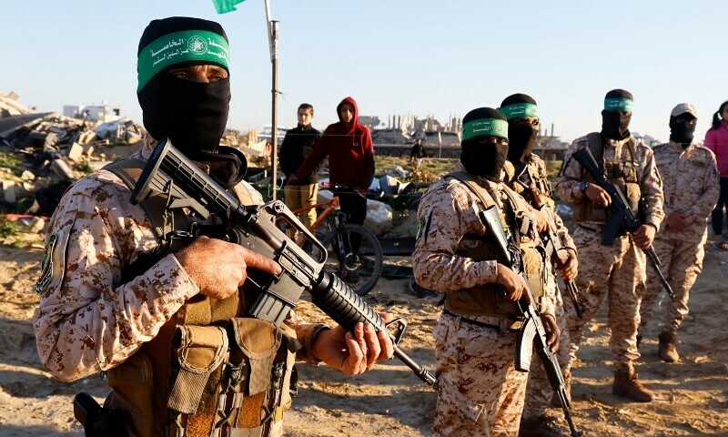 Hamas fighters stand guard before the release of Israeli hostages in Khan Younis, in the southern Gaza Strip. — Reuters