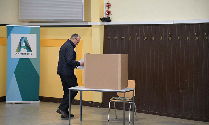  Friedrich Merz, leader of Germany’s conservative Christian Democratic Union (CDU) and his party’s main candidate for Chancellor, prepares to fill out his ballot papers for general elections at a polling station in Arnsberg, western Germany, on February 23. — AFP 
