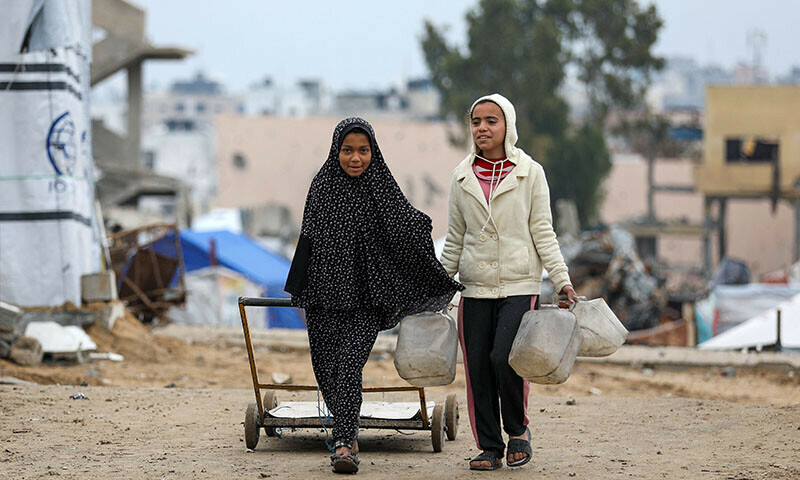 Palestinian girls walk to collect water, amid a ceasefire between Israel and Hamas, in Gaza City on February 22. — Reuters