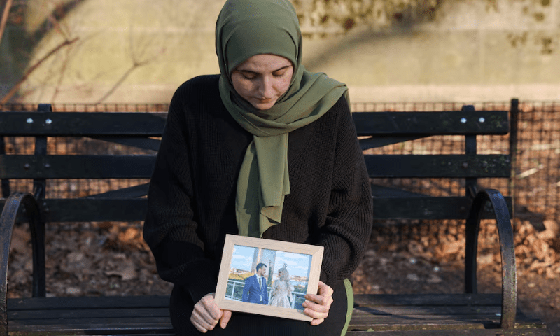 Noor Abdalla, 28, wife of Palestinian activist and Columbia University graduate student Mahmoud Khalil who was detained by ICE, sits for a portrait holding a photograph of their wedding day after an interview with Reuters in New York City, US on March 12. — Reuters