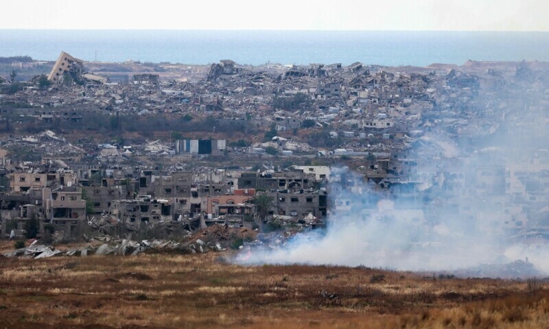  This picture taken from Israel&rsquo;s southern border with the Gaza Strip shows buring fields in front of destroyed houses in northern Gaza on May 4, 2025.&mdash;AFP 
