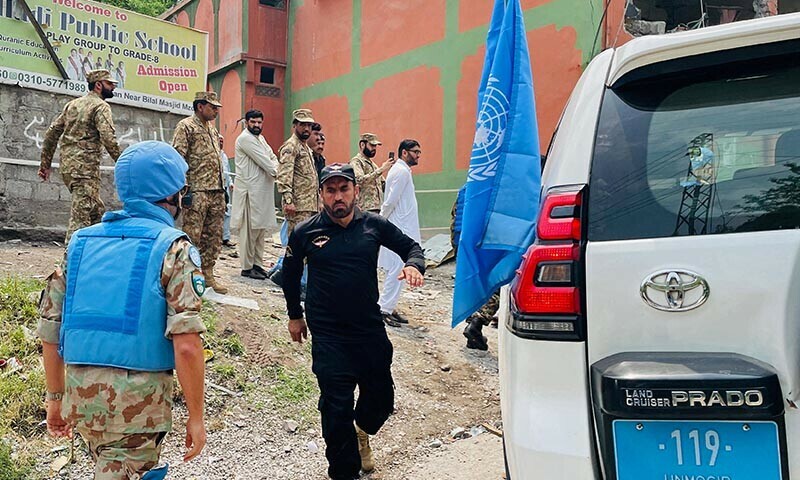 A UN military observer (L) arrives to inspect the site of a damaged mosque after Indian strikes in Muzaffarabad on May 7. &mdash; AFP