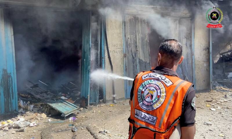  A member of the emergency services hoses down a fire in Khan Younis, Gaza after nine children of a doctor couple were killed in an Israeli strike on May 23, 2025, in this screengrab taken from video. &mdash; Palestinian Civil Defence/Handout via Reuters 