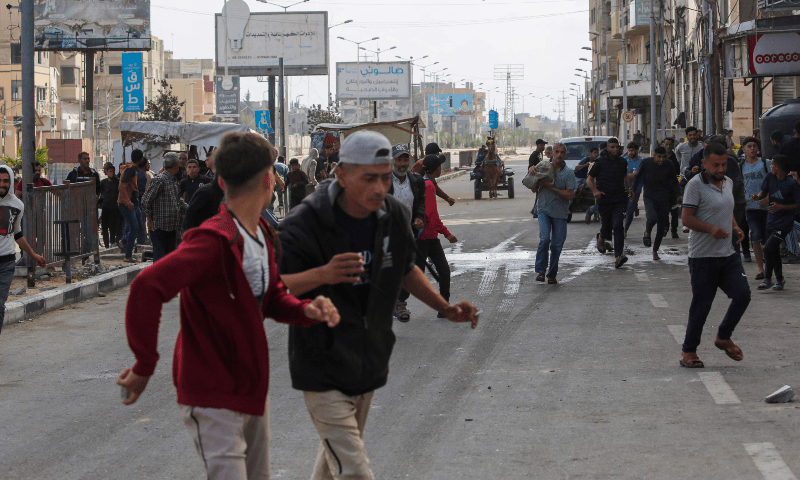 Palestinians react on a road in the area of an aid distribution point near the so-called “Netzarim checkpoint” in the central Gaza Strip on June 1, 2025. — AFP