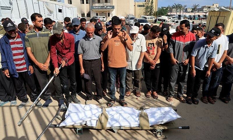 Mourners pray during the funeral of a Palestinian killed in what the Gaza health ministry says was Israeli fire near a distribution centre in Rafah, at Nasser hospital in Khan Younis, in the southern Gaza Strip on June 15. &mdash; Reuters