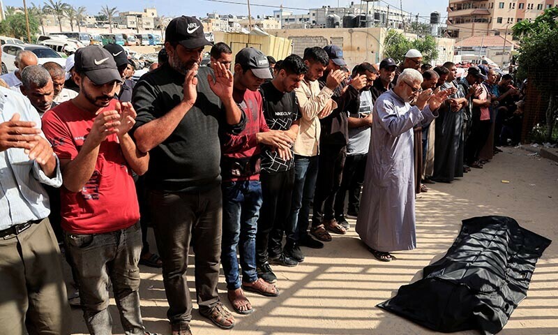Mourners pray during the funeral of a Palestinian killed in what the Gaza health ministry says was Israeli fire near a distribution centre in Rafah, at Nasser hospital in Khan Younis, in the southern Gaza Strip on June 15. &mdash; Reuters