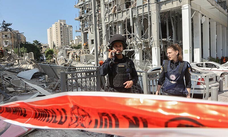 Israeli emergency services work at the site of an Iranian missile attack in Ramat Gan in central Israel near Tel Aviv, on June 19. &mdash; AFP