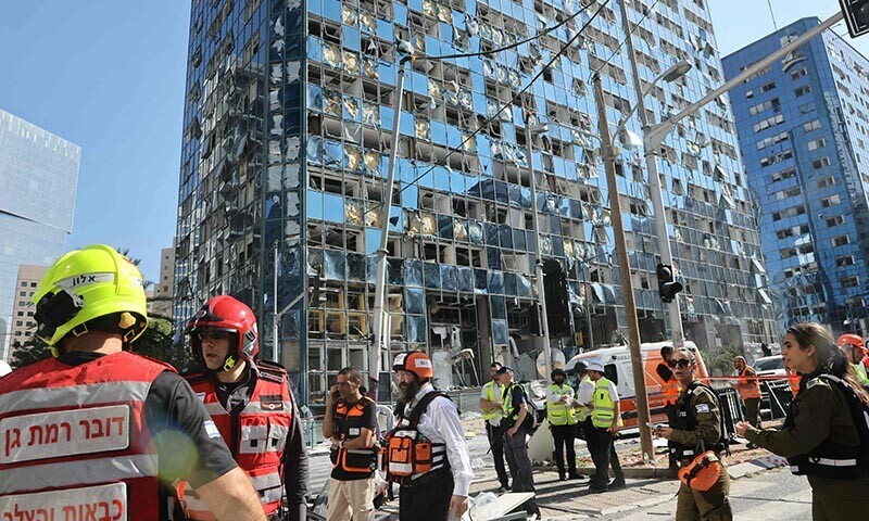 Emergency personnel work at an impact site following a missile strike from Iran on Israel, in Holon, Tel Aviv, Israel on June 19. &mdash; Reuters