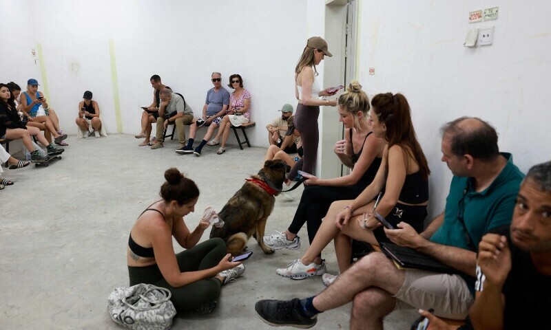 People gather in a underground shelter in Tel Aviv on June 23, 2025, after sirens sounded in several areas across the country after missiles were fired from Iran. — AFP