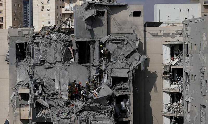 Emergency personnel work at an impacted residential site, following a missile attack from Iran on Israel, amid the Israel-Iran conflict, in Beersheba, Israel June 24. &mdash; Reuters