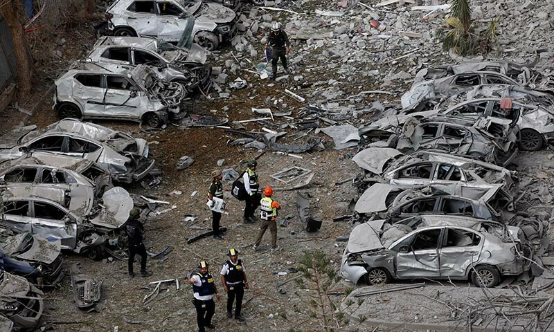 Emergency personnel work at an impacted residential site, following a missile attack from Iran on Israel, amid the Israel-Iran conflict, in Beersheba, Israel June 24. &mdash; Reuters